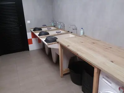 a bathroom with two sinks and a wooden counter at Albergue Milladoiro in Milladoiro
