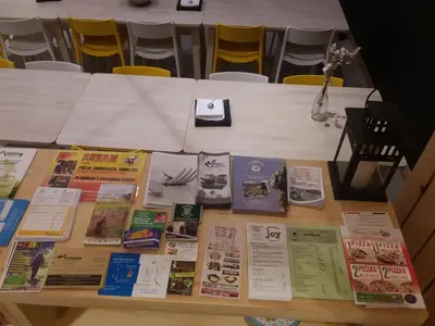 a table with many books on top of it at Albergue Milladoiro in Milladoiro