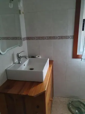 a bathroom with a white sink and a mirror at A Concha in Lavacolla