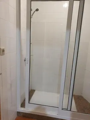 a shower with a glass door in a bathroom at A Concha in Lavacolla