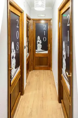 a hallway with two doors with numbers on them at A Morada do Cigarron in Verín