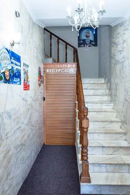 a set of stairs leading up to a brown door at A Morada do Cigarron in Verín