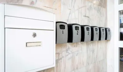 a row of iphones on a wall next to a refrigerator at A Morada do Cigarron in Verín