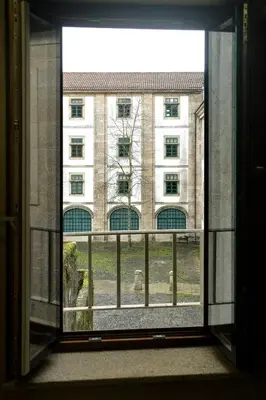 an open window with a view of a building at Numa Rúa Travesa in Santiago de Compostela