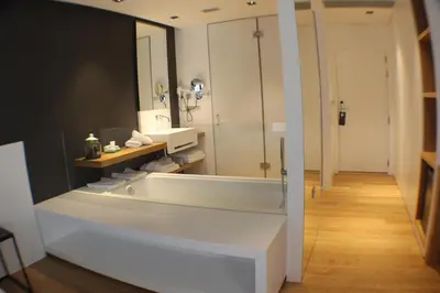 a bathroom with a bath tub and a shower at Hotel U Viveiro in Viveiro