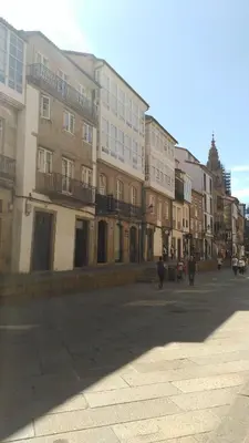 a group of buildings on a street with people walking at PICO SACRO I HOSTAL-PENSION Santiago de Compostela in Santiago de Compostela