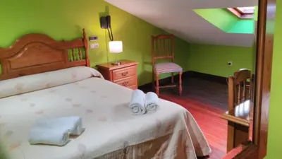 a bedroom with a bed with shoes on it at PICO SACRO I HOSTAL-PENSION Santiago de Compostela in Santiago de Compostela
