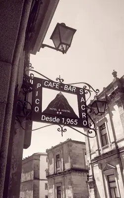 a cafe bar sign on the side of a building at PICO SACRO I HOSTAL-PENSION Santiago de Compostela in Santiago de Compostela