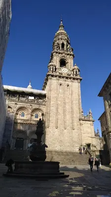a large building with a tower with a clock on it at PICO SACRO I HOSTAL-PENSION Santiago de Compostela in Santiago de Compostela