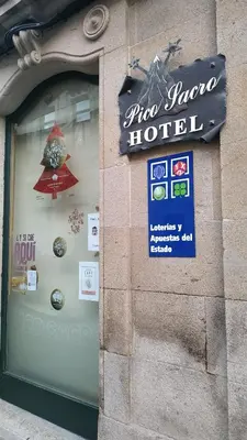 a store window with a sign for a hotel at PICO SACRO I HOSTAL-PENSION Santiago de Compostela in Santiago de Compostela