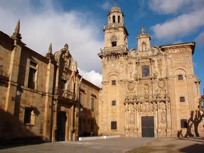 a large stone building with a clock tower at Casa do Merlo in Barreiros