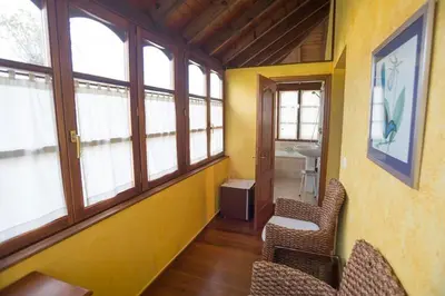 a room with chairs and windows in a building at Casa do Merlo in Barreiros