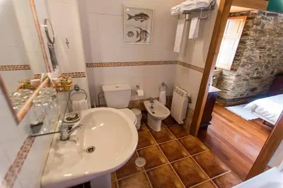 a bathroom with a sink and a toilet in it at Casa do Merlo in Barreiros