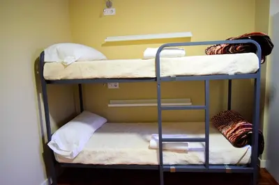 a room with two bunk beds in a room at Albergue Mirás in Sigüeiro