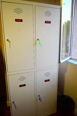 two white lockers in a room with a window at Albergue Mirás in Sigüeiro