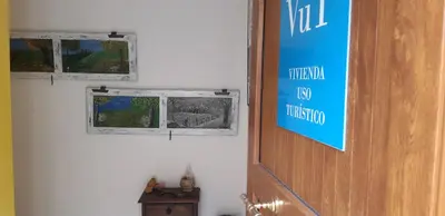 a door in a room with a sign on it at Casa Antonio y Benina in Sosas de Laciana