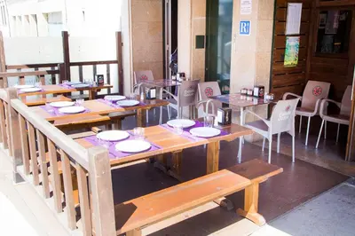 a row of tables and chairs in a restaurant at Pensión Restaurante Casa Camiño II in Palas de Rei