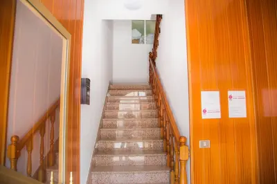 a staircase in a building with a stair case at Pensión Restaurante Casa Camiño II in Palas de Rei