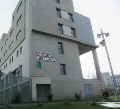 a building with a sign on the side of it at Residencia Universitaria Resa As Burgas in Ourense
