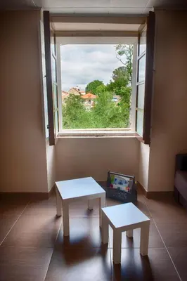a room with two tables in front of a window at Casa Saleta in Melide