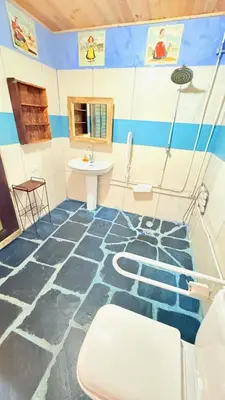 a bathroom with a blue and white floor with a sink at Pensión y Albergue Matias Locanda in Sarria