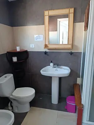a bathroom with a sink and a toilet and a mirror at Pensión y Albergue Matias Locanda in Sarria