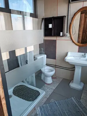 a bathroom with a sink and a toilet and a mirror at Pensión y Albergue Matias Locanda in Sarria