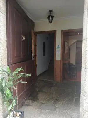 a hallway of a house with a door and a plant at Hostal Forest in Santiago de Compostela