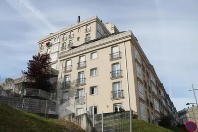 a tall white building on a hill at Viveiro in Viveiro