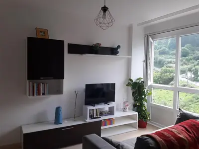 a living room with a flat screen tv on a wall at Viveiro in Viveiro