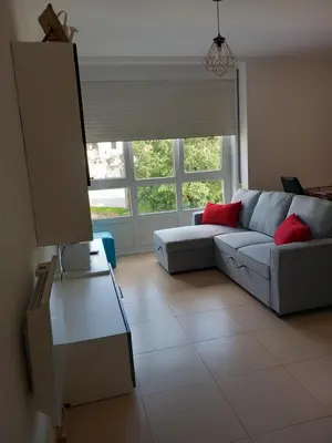 a living room with a couch and a window at Viveiro in Viveiro