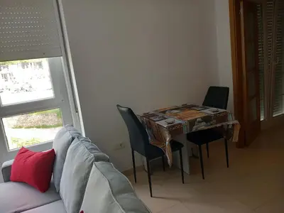a living room with a table and chairs and a couch at Viveiro in Viveiro