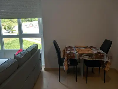 a room with a table and chairs and a couch at Viveiro in Viveiro