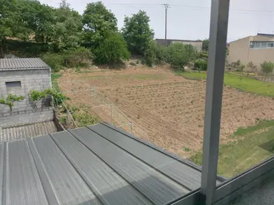 a view of a garden from a window at Pension Perez in Portomarin