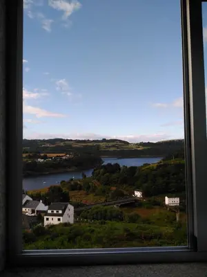 a view of a lake from a window at Pension Perez in Portomarin