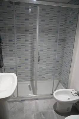 a bathroom with a shower and a toilet and a sink at Pension Perez in Portomarin