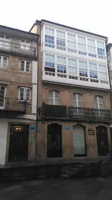 a tall building with windows on the side of it at PICO SACRO II HOTEL Santiago de Compostela in Santiago de Compostela