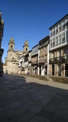 an empty street in a city with tall buildings at PICO SACRO II HOTEL Santiago de Compostela in Santiago de Compostela