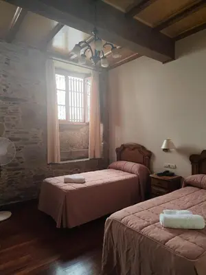 a bedroom with two beds and a window at PICO SACRO II HOTEL Santiago de Compostela in Santiago de Compostela