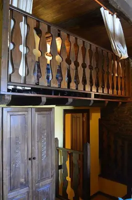 a wooden staircase with many utensils hanging from it at Apartamentos Casa de Riba in Teijeira