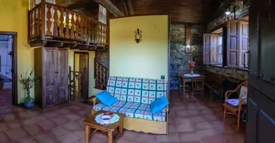 a living room with a couch and a table at Apartamentos Casa de Riba in Teijeira