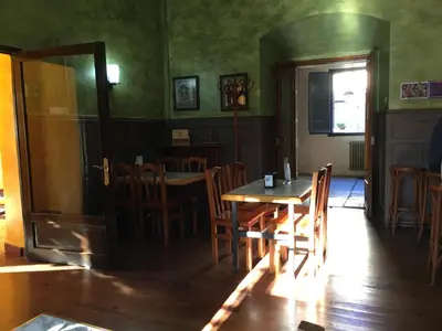 a dining room with a wooden table and chairs at San Nicolas el Real in Villafranca del Bierzo