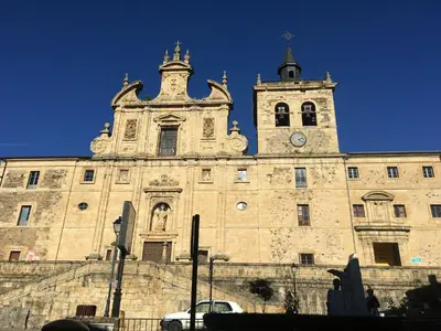 a large building with a clock tower on top of it at San Nicolas el Real in Villafranca del Bierzo