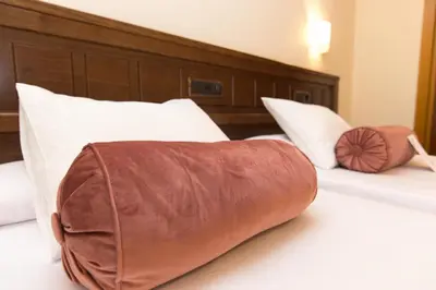 a hotel room with two beds with white pillows at Hotel Garelos Betanzos in Betanzos
