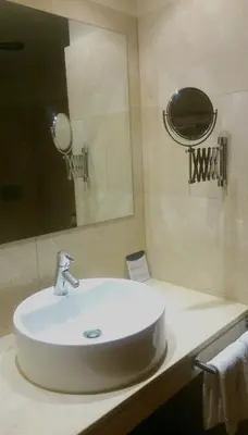 a bathroom with a white sink and a mirror at Hotel Garelos Betanzos in Betanzos