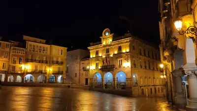 an old building with a clock on top of it at night at Céntrico Burgas Termal in Ourense