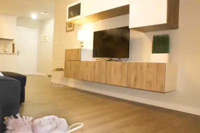 a living room with a flat screen tv on a wall at Céntrico Burgas Termal in Ourense