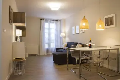 a living room with a table and a couch at Céntrico Burgas Termal in Ourense