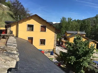 a yellow house on top of a roof at Os Arroxos in Trabadelo