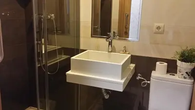 a bathroom with a white sink and a shower at Albergue Ultreia in Arzúa
